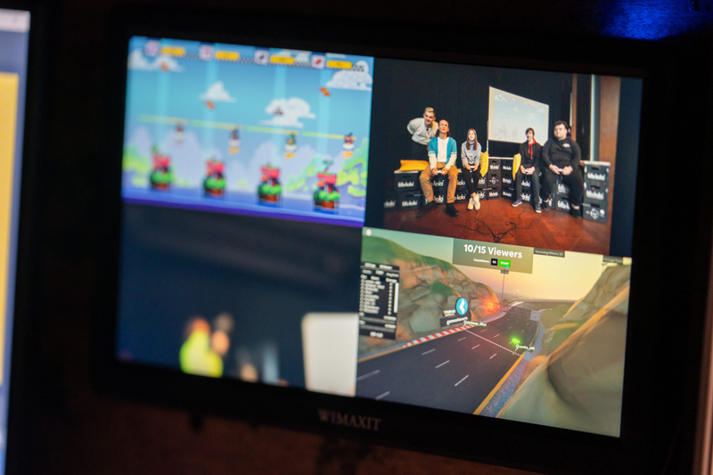 A screen with multiple feeds of a game and people playing it